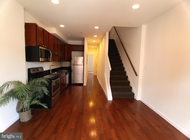 kitchen with sink, stainless steel appliances, and dark hardwood / wood-style floors