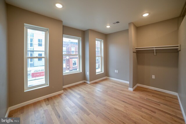 unfurnished room with light wood-type flooring