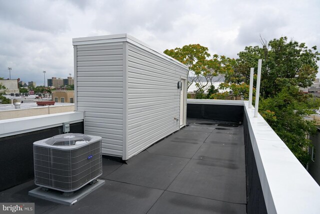 view of patio / terrace with cooling unit and a balcony