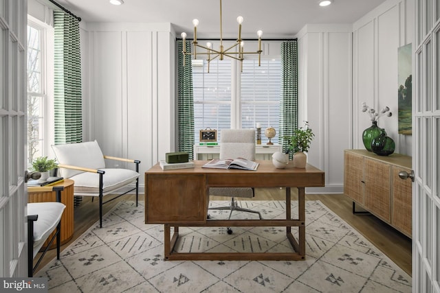 office with french doors, light hardwood / wood-style flooring, and a notable chandelier