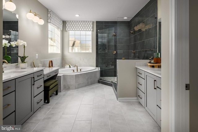 bathroom featuring shower with separate bathtub, vanity, and tile patterned floors