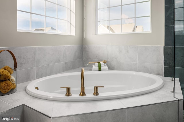 bathroom featuring tiled bath