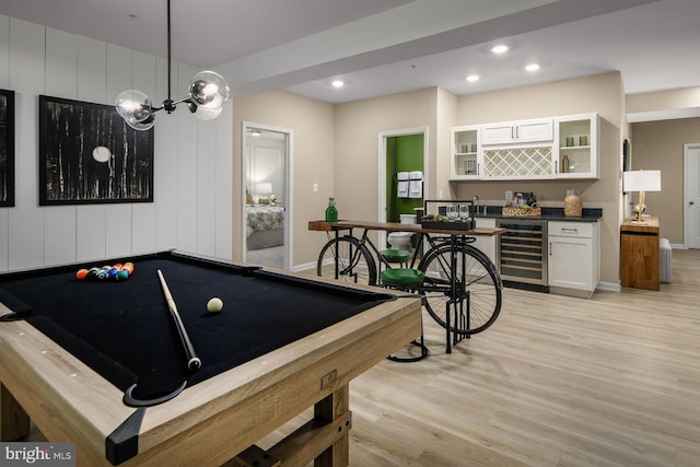 rec room featuring beverage cooler, an inviting chandelier, billiards, indoor bar, and light wood-type flooring