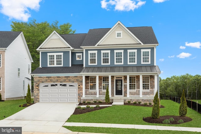 view of front of house featuring a porch, a garage, and a front lawn