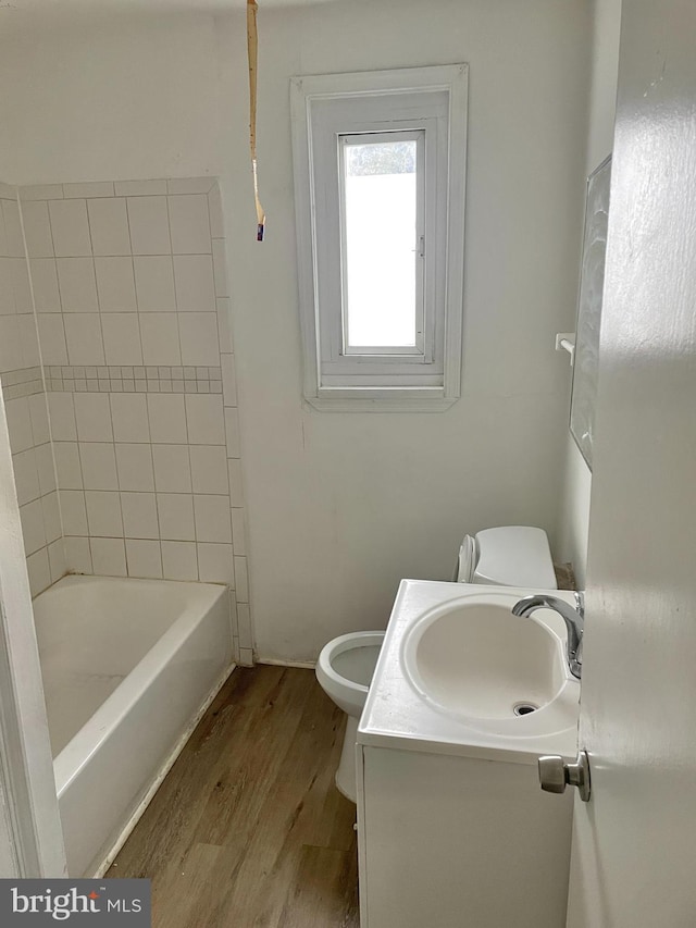 bathroom with vanity, hardwood / wood-style floors, and toilet