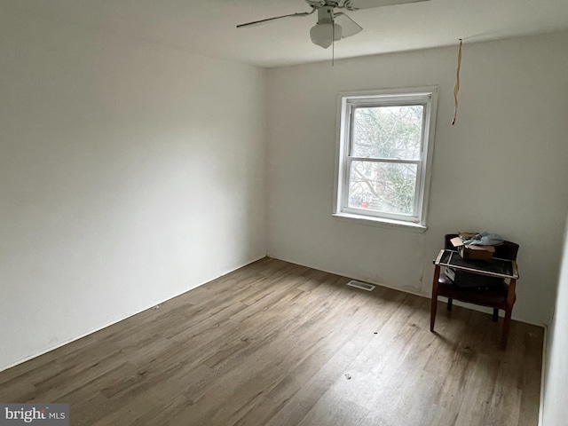 spare room featuring hardwood / wood-style flooring and ceiling fan