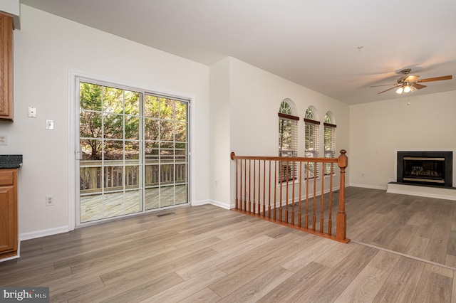 living room with light wood-type flooring and ceiling fan