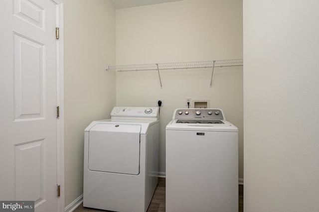 washroom featuring dark hardwood / wood-style floors and independent washer and dryer