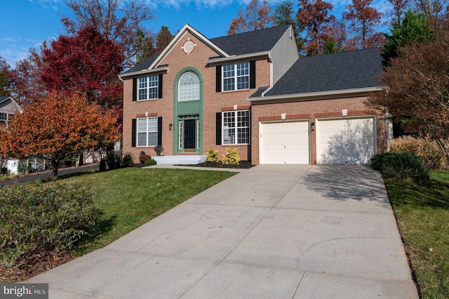 view of front of home with a garage and a front lawn