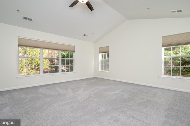 empty room with ceiling fan, carpet, and vaulted ceiling