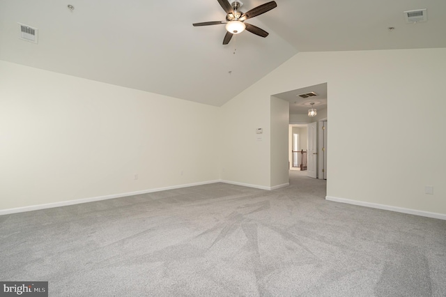 spare room with carpet floors, vaulted ceiling, and ceiling fan