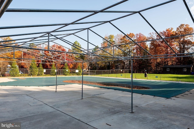 view of swimming pool with a lawn and a lanai