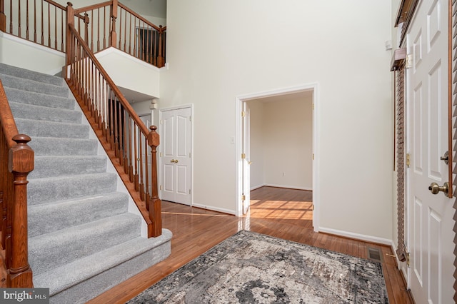 entrance foyer featuring hardwood / wood-style floors and a high ceiling