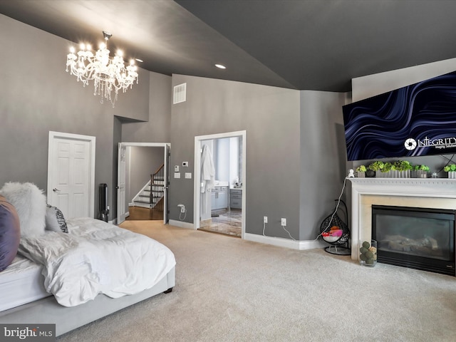 carpeted bedroom with a chandelier, connected bathroom, and high vaulted ceiling