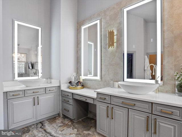 bathroom featuring vanity and tile walls