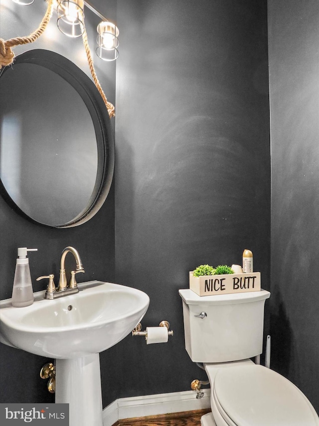 bathroom with sink, wood-type flooring, and toilet