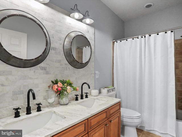 bathroom featuring tile patterned floors, curtained shower, vanity, and toilet