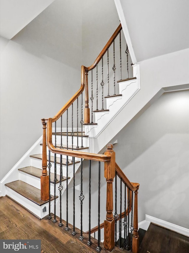 staircase with wood-type flooring