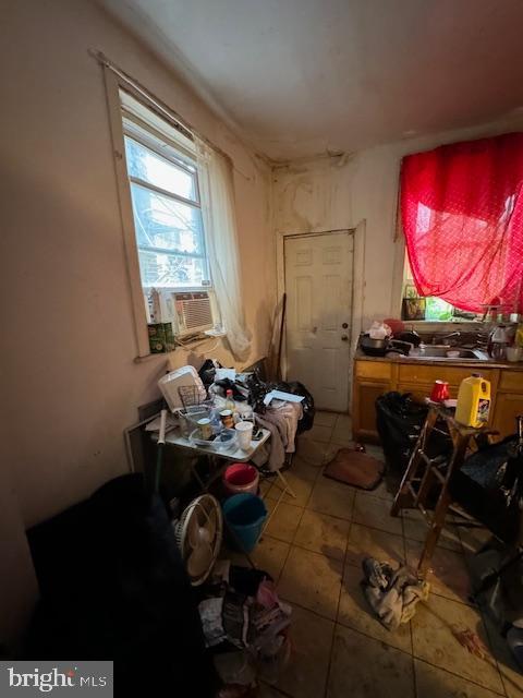 miscellaneous room featuring tile patterned flooring, cooling unit, and sink