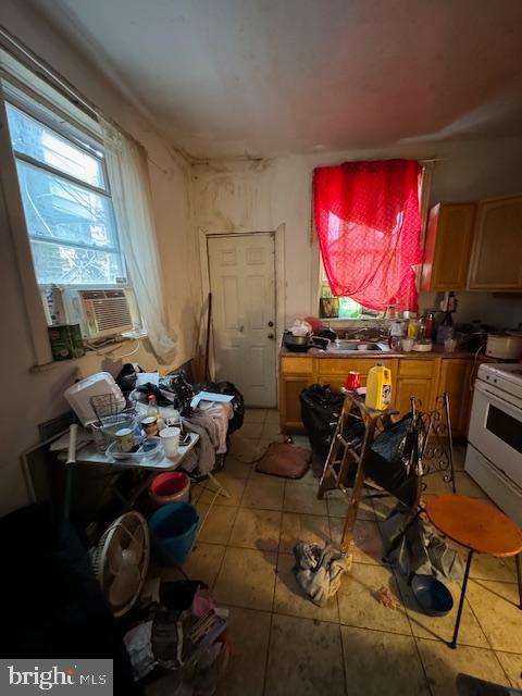 miscellaneous room featuring tile patterned floors, cooling unit, and sink