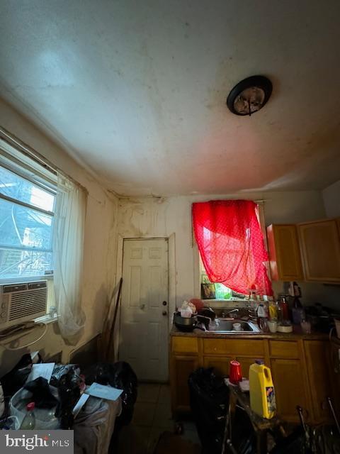 misc room with cooling unit, light tile patterned floors, and sink