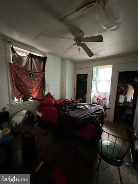 bedroom featuring ceiling fan and concrete floors