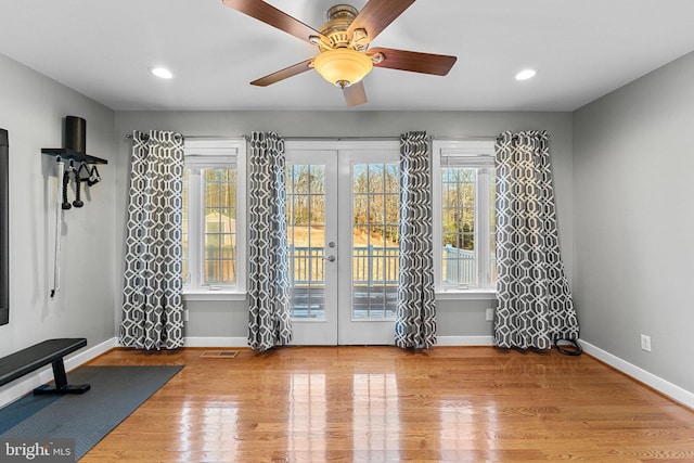 interior space featuring hardwood / wood-style floors, ceiling fan, and french doors