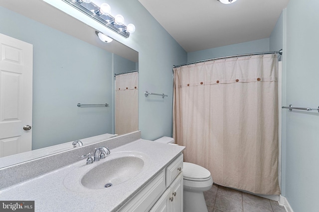 bathroom featuring toilet, vanity, tile patterned floors, and walk in shower