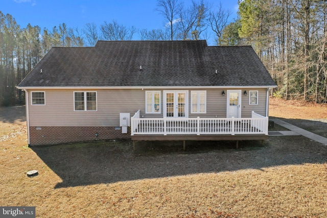 back of property with a deck, a yard, and french doors