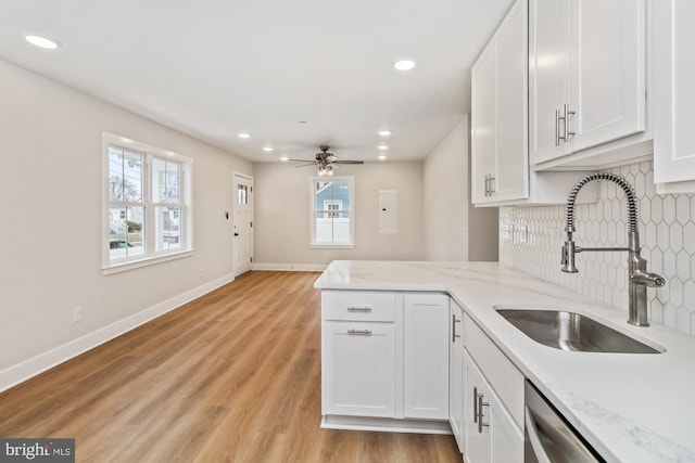 kitchen featuring white cabinetry, sink, a wealth of natural light, and light hardwood / wood-style flooring