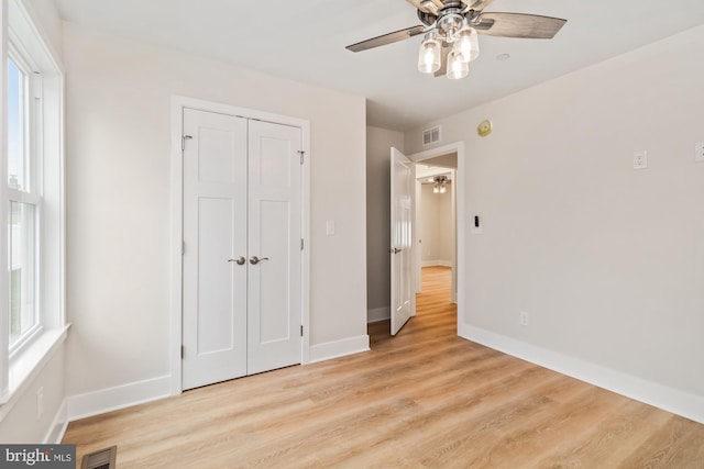 unfurnished bedroom featuring a closet, ceiling fan, and light hardwood / wood-style flooring