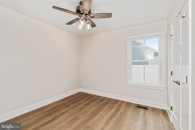 unfurnished room featuring ceiling fan and light wood-type flooring