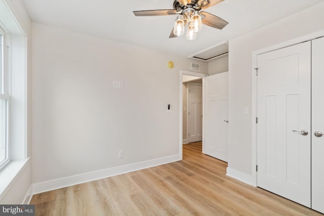 unfurnished bedroom with ceiling fan, a closet, and light hardwood / wood-style floors