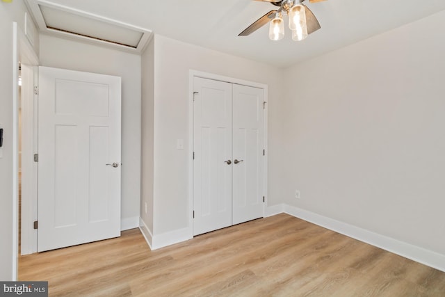 unfurnished bedroom with ceiling fan, a closet, and light hardwood / wood-style flooring