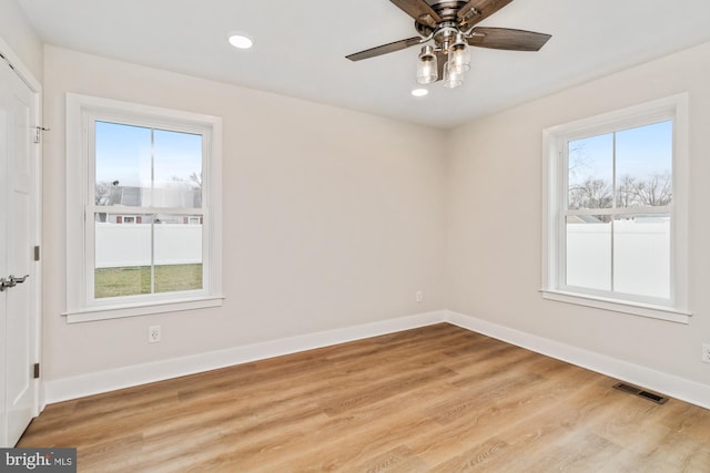 unfurnished room with ceiling fan, a healthy amount of sunlight, and light hardwood / wood-style floors