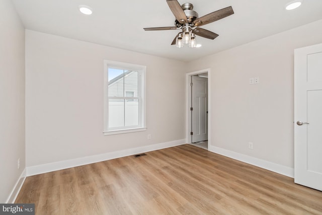 spare room featuring light hardwood / wood-style flooring and ceiling fan