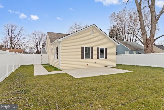 back of house featuring a yard and a patio