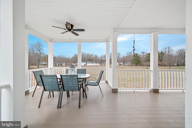 sunroom featuring ceiling fan