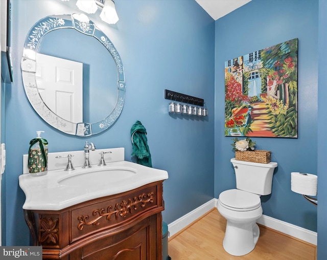 bathroom featuring hardwood / wood-style floors, vanity, and toilet