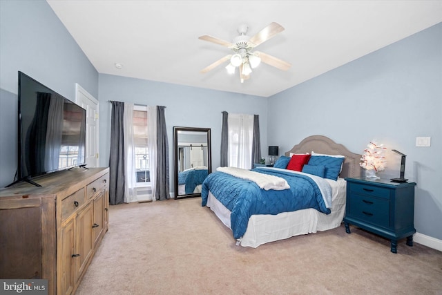 bedroom with ceiling fan and light colored carpet