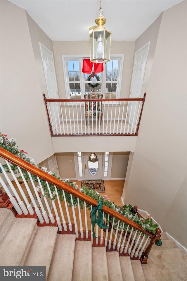 stairs with a chandelier