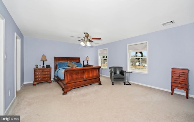 bedroom with ceiling fan and light colored carpet