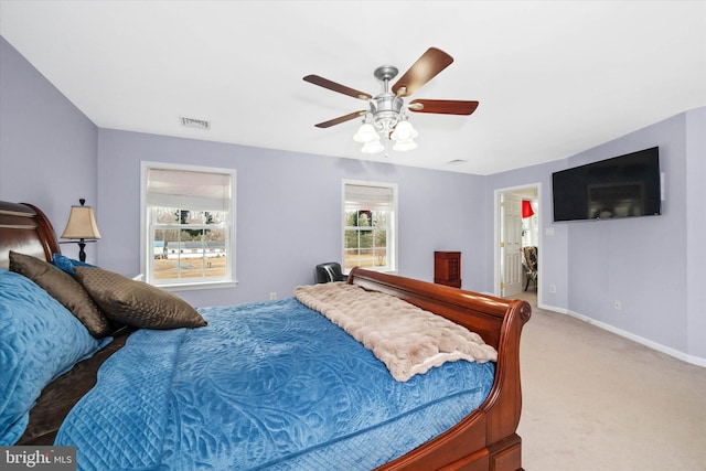 carpeted bedroom with ceiling fan and connected bathroom