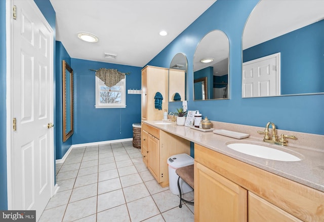 bathroom featuring tile patterned flooring and vanity