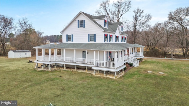 view of front of property featuring a front yard, a porch, and a storage shed