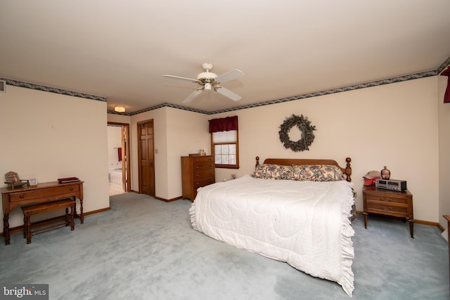 carpeted bedroom with connected bathroom and ceiling fan