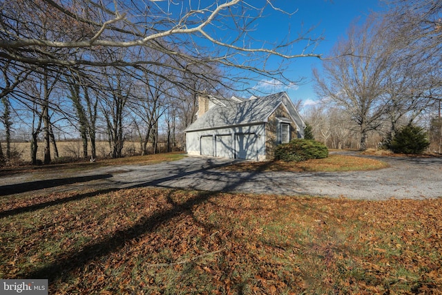 view of property exterior with an outbuilding and a garage