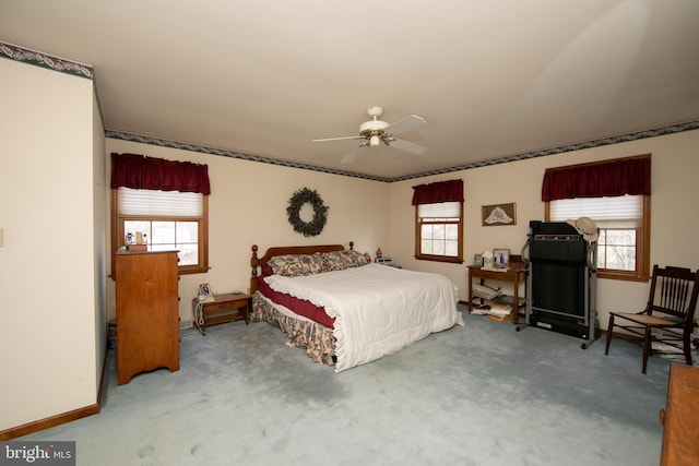 bedroom featuring multiple windows, ceiling fan, and carpet