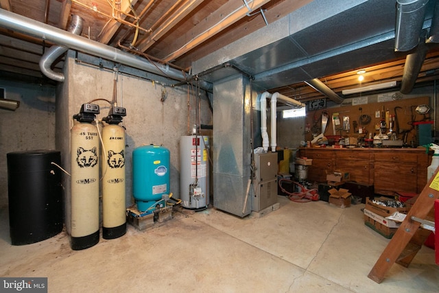 basement featuring a workshop area, heating unit, and gas water heater