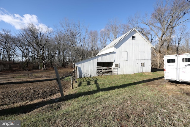 view of outbuilding featuring a yard